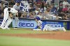 New York Mets' Jose Iglesias (11) beats the throw to Miami Marlins third baseman Emmanuel Rivera, left, for a triple during the fourth inning of a baseball game, Monday, July 22, 2024, in Miami. (AP Photo/Lynne Sladky)