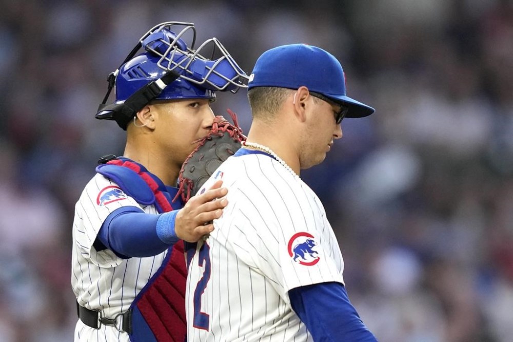 Chicago Cubs catcher Miguel Amaya talks with starting pitcher Javier Assad during the third inning of a baseball game against the Milwaukee Brewers Monday, July 22, 2024, in Chicago. (AP Photo/Charles Rex Arbogast)