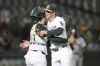 Oakland Athletics catcher Shea Langeliers, left, celebrates with pitcher Mason Miller after the Athletics defeated the Houston Astros in a baseball game in Oakland, Calif., Monday, July 22, 2024. (AP Photo/Jeff Chiu)