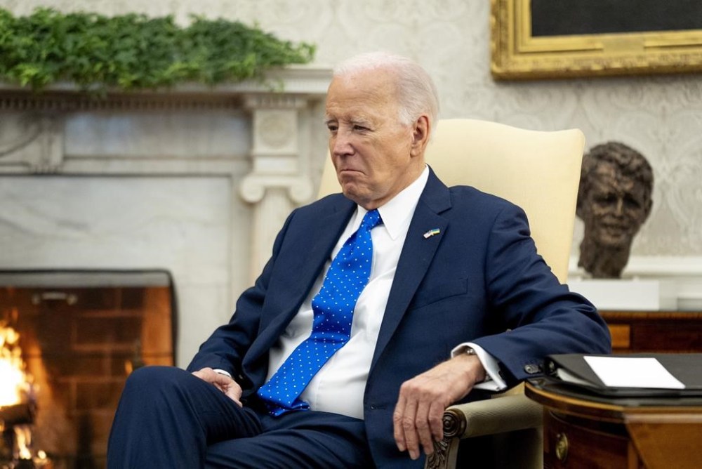 FILE - President Joe Biden sits in the Oval Office of the White House, Feb. 9, 2024, in Washington. Biden says he's