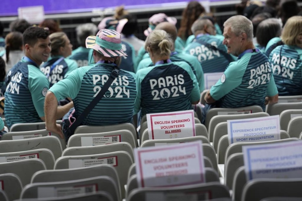 Volunteers are seen inside the State de France ahead of the 2024 Summer Olympics, Sunday, July 21, 2024, in Saint-Denis, France. (AP Photo/Tsvangirayi Mukwazhi)