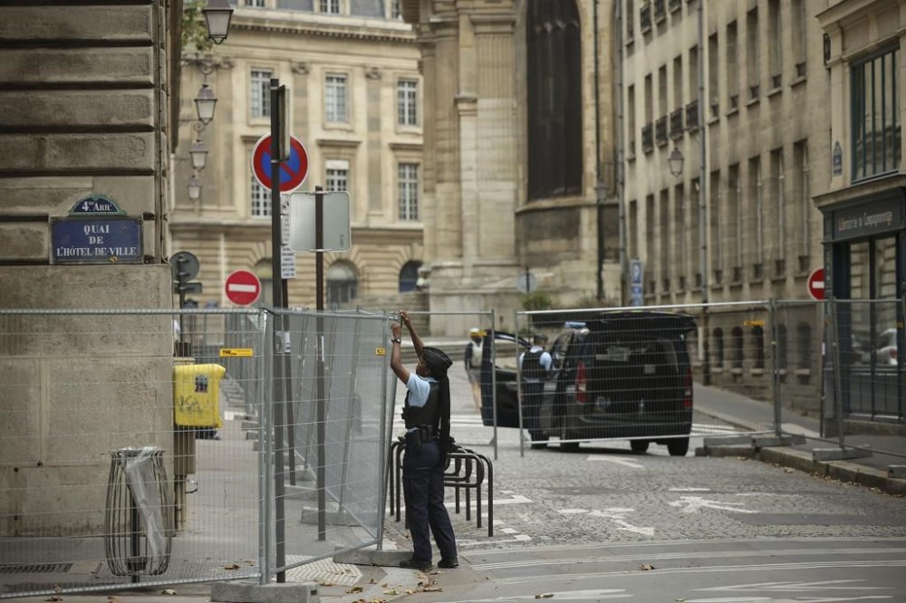 FILE - A police officer attaches fences at the security perimeter at the 2024 Summer Olympics, Sunday, July 21, 2024, in Paris, France.T hree days before the start of the Olympics, France's Interior Minister has hailed the country’s law enforcement for their hard work in making the Paris Games safe for 10,500 athletes and millions of visitors. (AP Photo/Thomas Padilla, File)