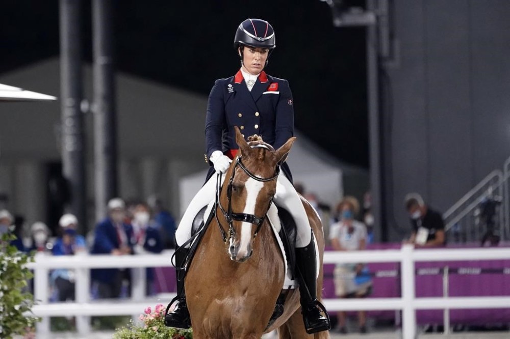 FILE - Britain's Charlotte Dujardin, riding Gio, competes in the equestrian dressage individual final at the 2020 Summer Olympics, Wednesday, July 28, 2021, in Tokyo. Three-time Olympic gold medalist Charlotte Dujardin of Great Britain has withdrawn from the Paris Games after a video emerged that she says shows her behaving inappropriately while coaching other riders. (AP Photo/David Goldman, File)