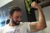 FILE - Fernando Dayán Jorge displays an Olympic tattoo on his bicep, June 26, 2024, in Cape Coral, Fla. On Tuesday, July 13, the Cuban Olympic Committee demanded the “immediate exclusion” of an island athlete who was included by the organizers as part of a refugee team that will participate in the Paris 2024 Olympic Games. The committee did not mention the name of the athlete, but canoeist Dayán Jorge has been outspoken in his criticism of the country. (AP Photo/Rebecca Blackwell, File)