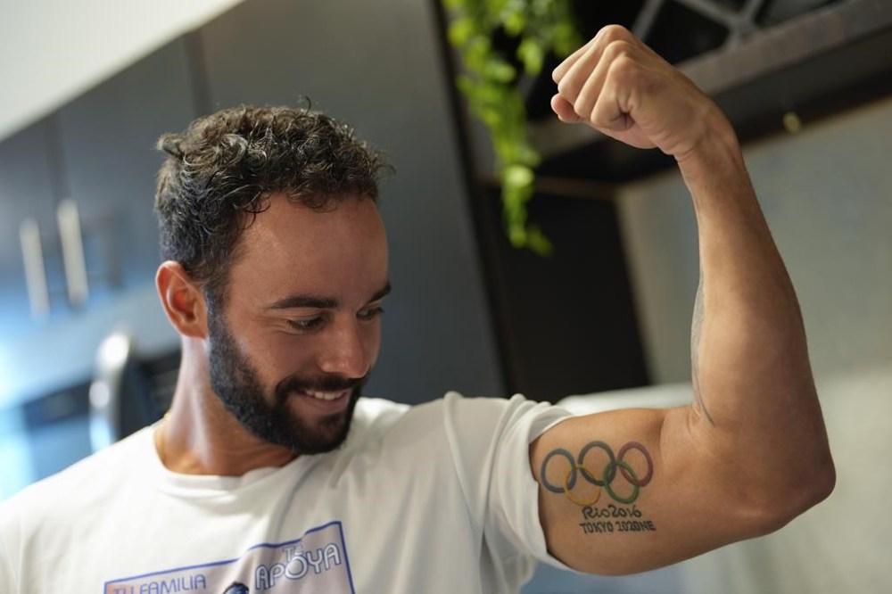 FILE - Fernando Dayán Jorge displays an Olympic tattoo on his bicep, June 26, 2024, in Cape Coral, Fla. On Tuesday, July 13, the Cuban Olympic Committee demanded the “immediate exclusion” of an island athlete who was included by the organizers as part of a refugee team that will participate in the Paris 2024 Olympic Games. The committee did not mention the name of the athlete, but canoeist Dayán Jorge has been outspoken in his criticism of the country. (AP Photo/Rebecca Blackwell, File)