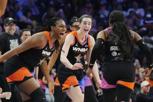 Arike Ogunbowale, right, of Team WNBA, celebrates after her 3-point basket against Team USA with teammates Caitlin Clark, center, and Aliyah Boston, left, during the second half of a WNBA All-Star basketball game Saturday, July 20, 2024, in Phoenix. (AP Photo/Ross D. Franklin)