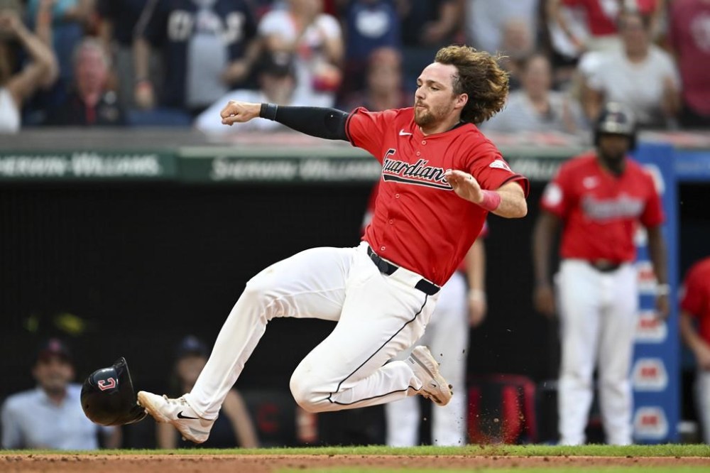 Cleveland Guardians' Daniel Schneemann scores on a single hit by José Ramírez during the sixth inning of a baseball game against the Detroit Tigers, Tuesday, July 23, 2024, in Cleveland. (AP Photo/Nick Cammett)