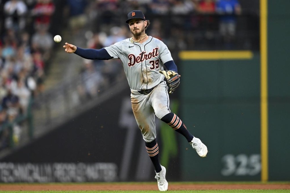 Detroit Tigers' Zach McKinstry throws out Cleveland Guardians' Tyler Freeman at first base during the seventh inning of a baseball game, Tuesday, July 23, 2024, in Cleveland. (AP Photo/Nick Cammett)