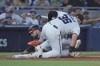 Miami Marlins third baseman Jake Burger (36) tags out Baltimore Orioles' Colton Cowser during the third inning of a baseball game, Tuesday, July 23, 2024, in Miami. (AP Photo/Wilfredo Lee)