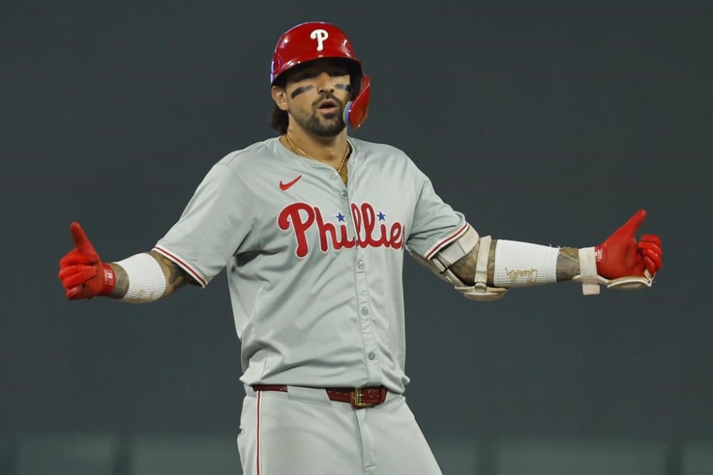 Philadelphia Phillies' Nick Castellanos celebrates his two-run double against the Minnesota Twins in the ninth inning of a baseball game, Tuesday, July 23, 2024, in Minneapolis. (AP Photo/Bruce Kluckhohn)