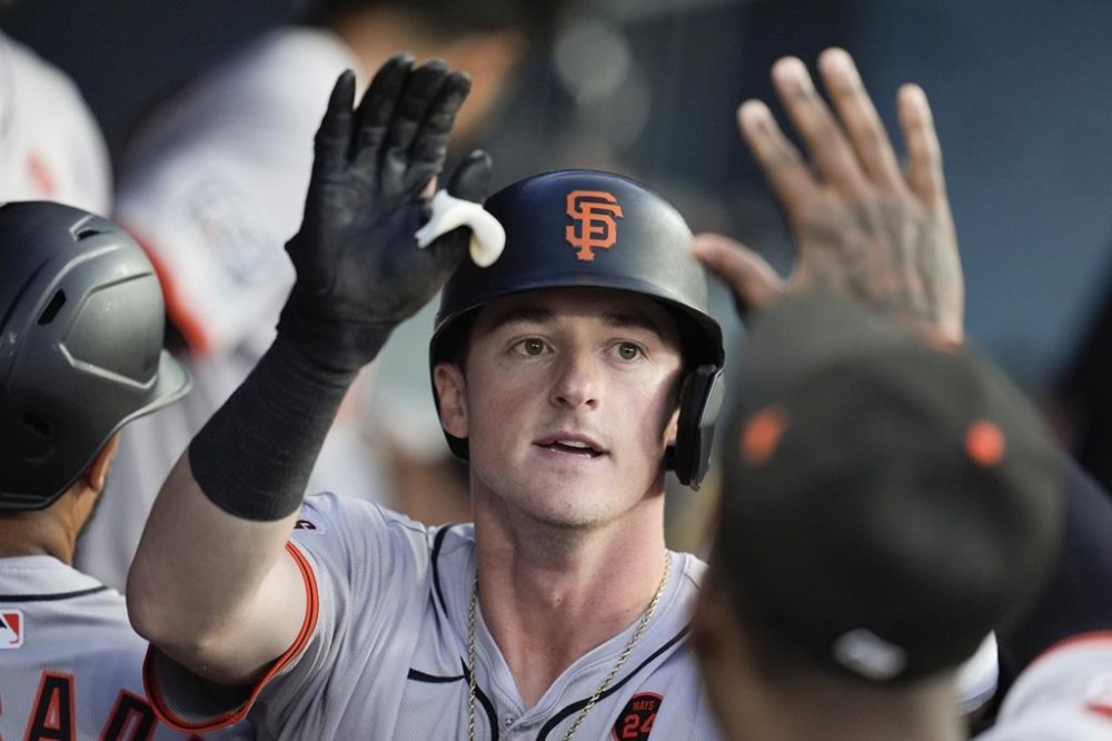 San Francisco Giants' Tyler Fitzgerald celebrates in the dugout after his solo home run during the second inning of a baseball game against the Los Angeles Dodgers, Tuesday, July 23, 2024, in Los Angeles. (AP Photo/Marcio Jose Sanchez)