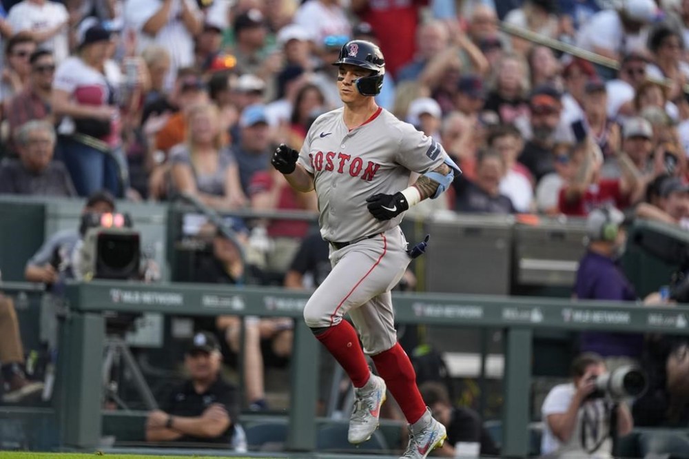 Boston Red Sox's Tyler O'Neill circles the bases after hitting a solo home run off Colorado Rockies starting pitcher Ty Blach in the third inning of a baseball game Tuesday, July 23, 2024, in Denver. (AP Photo/David Zalubowski)