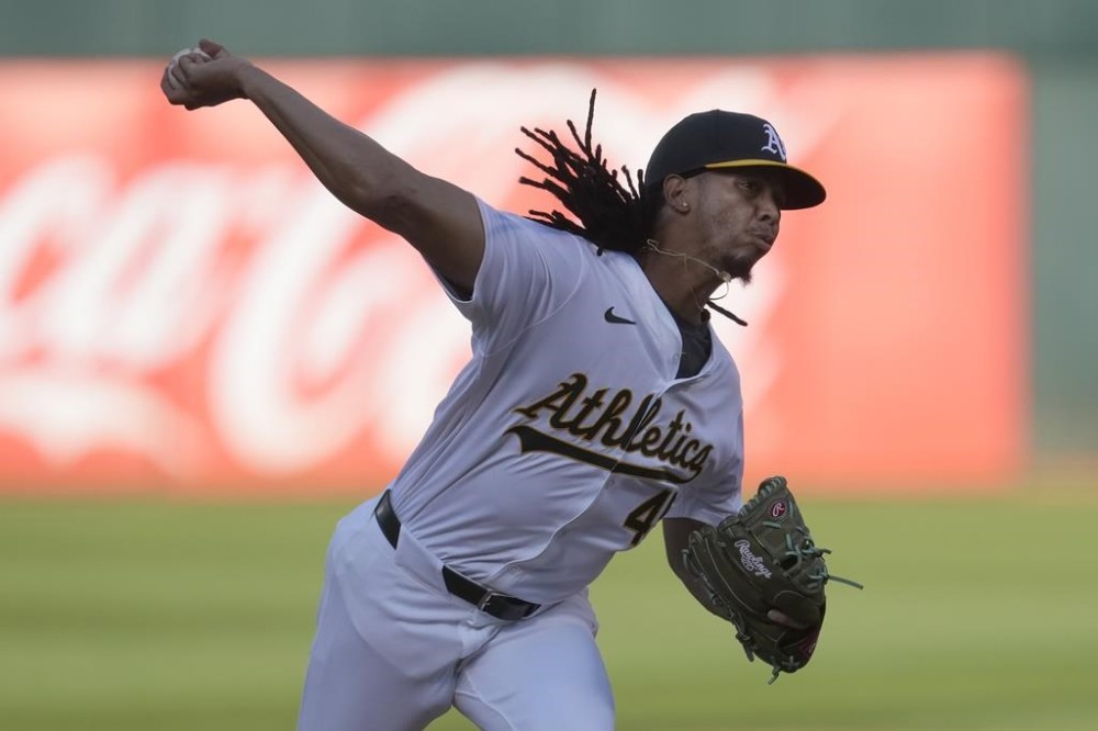Oakland Athletics pitcher Osvaldo Bido works against the Houston Astros during the first inning of a baseball game in Oakland, Calif., Tuesday, July 23, 2024. (AP Photo/Jeff Chiu)