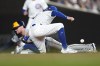 Milwaukee Brewers' Brice Turang steals second as Chicago Cubs' Dansby Swanson is unable to handle a throw from catcher Miguel Amaya during the first inning of a baseball game, Tuesday, July 23, 2024, in Chicago. (AP Photo/Charles Rex Arbogast)