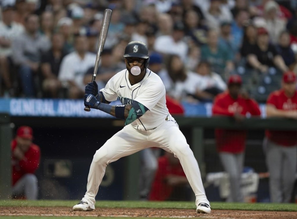 Seattle Mariners' Victor Robles blows a bubble during an at-bat in the eighth inning of a baseball game against the Los Angeles Angels, Tuesday, July 23, 2024, in Seattle. (AP Photo/Stephen Brashear)