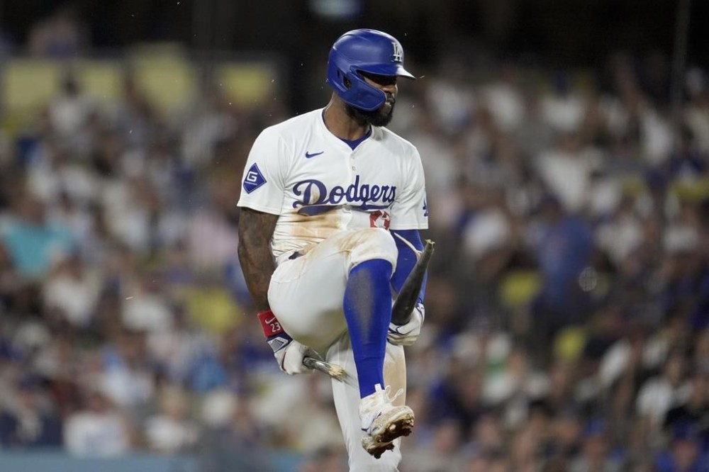 Los Angeles Dodgers' Jason Heyward breaks his bat over his leg after lining out to end the fifth inning of a baseball game against the San Francisco Giants, Tuesday, July 23, 2024, in Los Angeles. (AP Photo/Marcio Jose Sanchez)