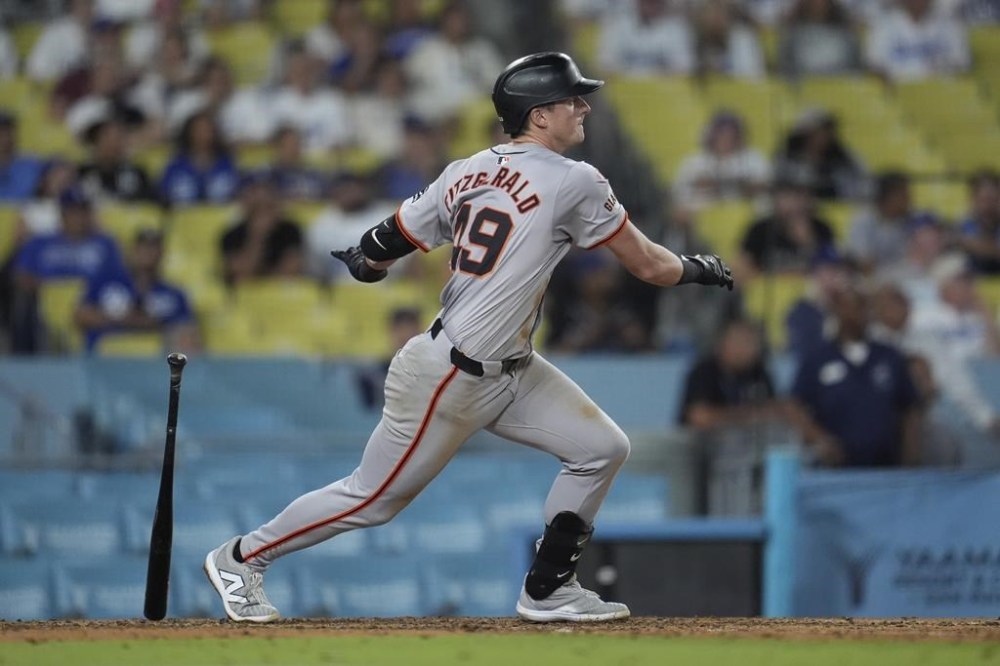 San Francisco Giants' Tyler Fitzgerald drives in a run with a single during the ninth inning of a baseball game against the Los Angeles Dodgers, Tuesday, July 23, 2024, in Los Angeles. (AP Photo/Marcio Jose Sanchez)