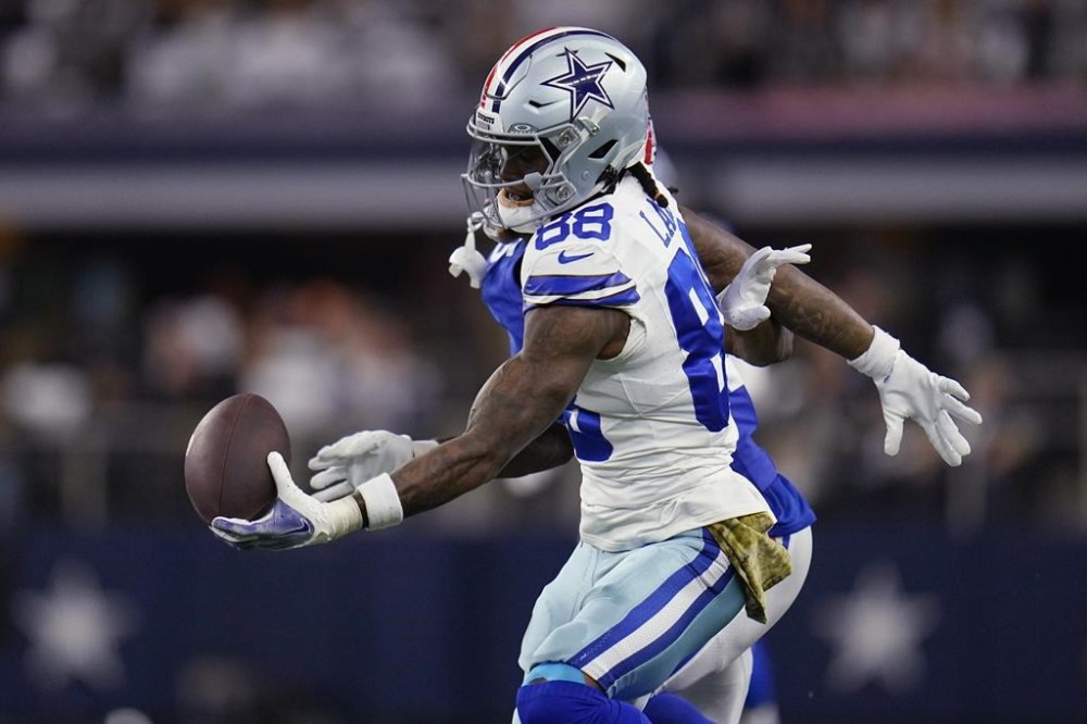 FILE - Dallas Cowboys wide receiver CeeDee Lamb (88) makes a one handed catch in front of New York Giants cornerback Deonte Banks, rear, in the first half of an NFL football game, Sunday, Nov. 12, 2023, in Arlington, Texas. (AP Photo/Julio Cortez, File)