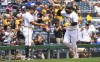Pittsburgh Pirates' Rowdy Tellez, right, is greeted by third base coach Mike Rabelo as he rounds the bases after hitting a solo home run during the fourth inning of a baseball game against the St. Louis Cardinals in Pittsburgh, Wednesday, July 24, 2024. (AP Photo/Justin Berl)