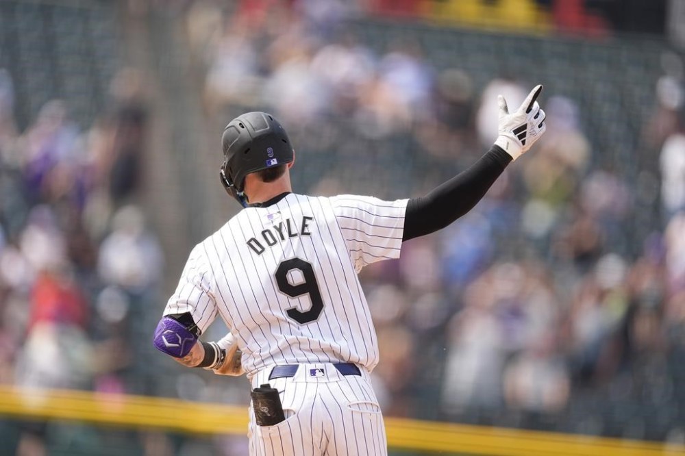 Colorado Rockies' Brenton Doyle gestures to the bullpen as he rounds the bases after hitting a grand slam off Boston Red Sox relief pitcher Chase Anderson in the sixth inning of a baseball game Wednesday, July 24, 2024, in Denver. (AP Photo/David Zalubowski)