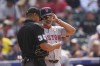 Boston Red Sox manager Alex Cora, right, chekcs in with home plate umpire Jeremie Rehak to make lineup changes in the eighth inning of a baseball game against the Colorado Rockies, Wednesday, July 24, 2024, in Denver. (AP Photo/David Zalubowski)