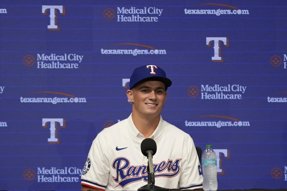 Texas Rangers first round draft pick catcher Malcolm Moore smiles during a news conference in Arlington, Texas, Wednesday, July 24, 2024. (AP Photo/LM Otero)
