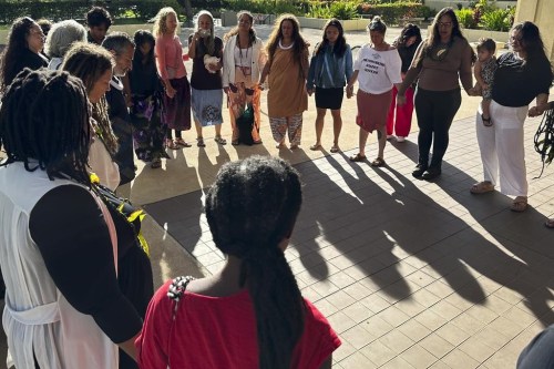 FILE - Supporters of a lawsuit challenging a Hawaii midwife licensure law gather outside a courthouse in Honolulu, June 10, 2024. On Monday, July 22, a Hawaii judge temporarily blocked the state from enforcing a licensure law against those who practice and teach traditional Native Hawaiian midwifery. (AP Photo/Jennifer Sinco Kelleher, File)
