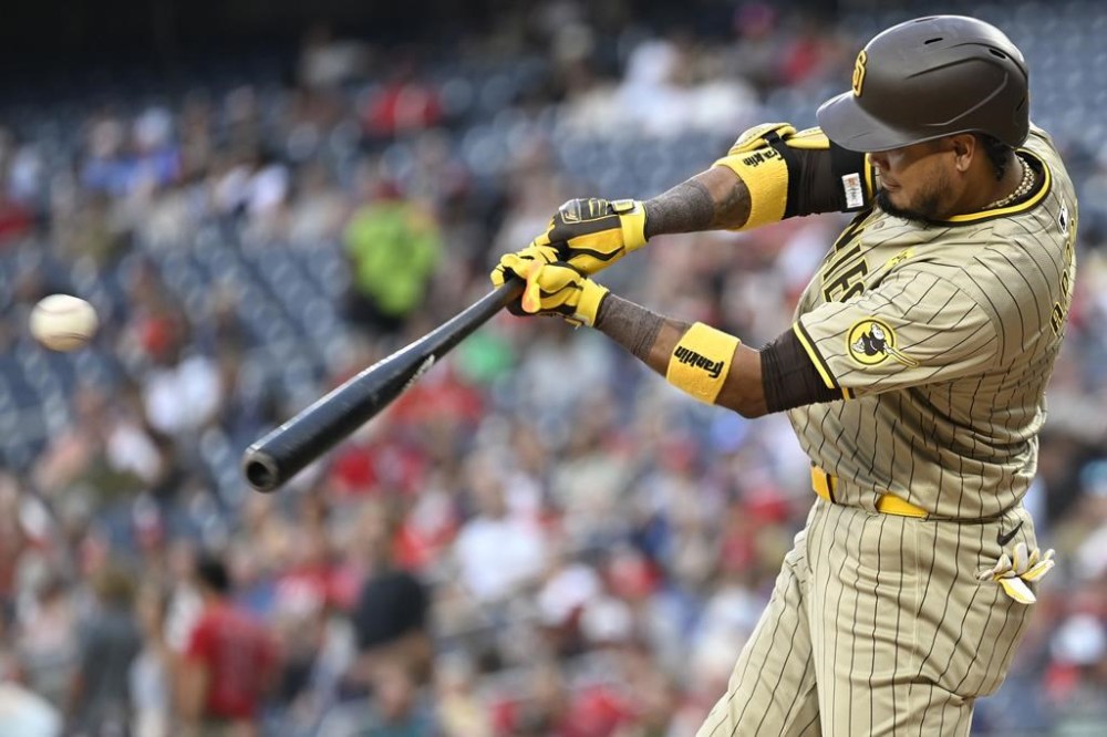 San Diego Padres' Luis Arraez hits a two-run single during the second inning of a baseball game against the Washington Nationals, Wednesday, July 24, 2024, in Washington. (AP Photo/John McDonnell)