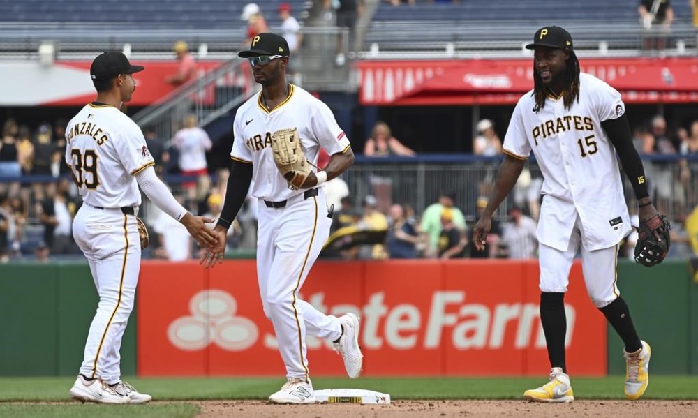 Pittsburgh Pirates' Nick Gonzales, left, Michael A. Taylor, middle, and Oneil Cruz, right, celebrate their team's win over the St. Louis Cardinals in a baseball game in Pittsburgh, Wednesday, July 24, 2024. (AP Photo/Justin Berl)