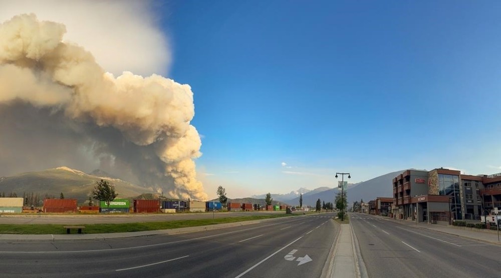 A wildfire burns as an empty street in Jasper, Alta. is shown in this Wednesday, July 24, 2024 handout photo from the Jasper National Park Facebook page. THE CANADIAN PRESS/HO, Facebook, Jasper National Park *MANDATORY CREDIT*
