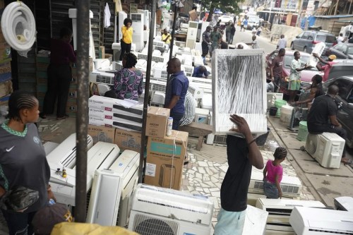 People sell air conditioners on the street in Lagos, Nigeria, Monday, July 15, 2024. (AP Photo/Sunday Alamba)