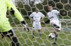 FILE - French President Emmanuel Macron scores a penalty as he participates in the Varietes Club charity football match to benefit children in the hospital, at the Bernard Giroux stadium in Plaisir, outside Paris, France, April 24, 2024. (Benoit Tessier/Pool via AP, File)