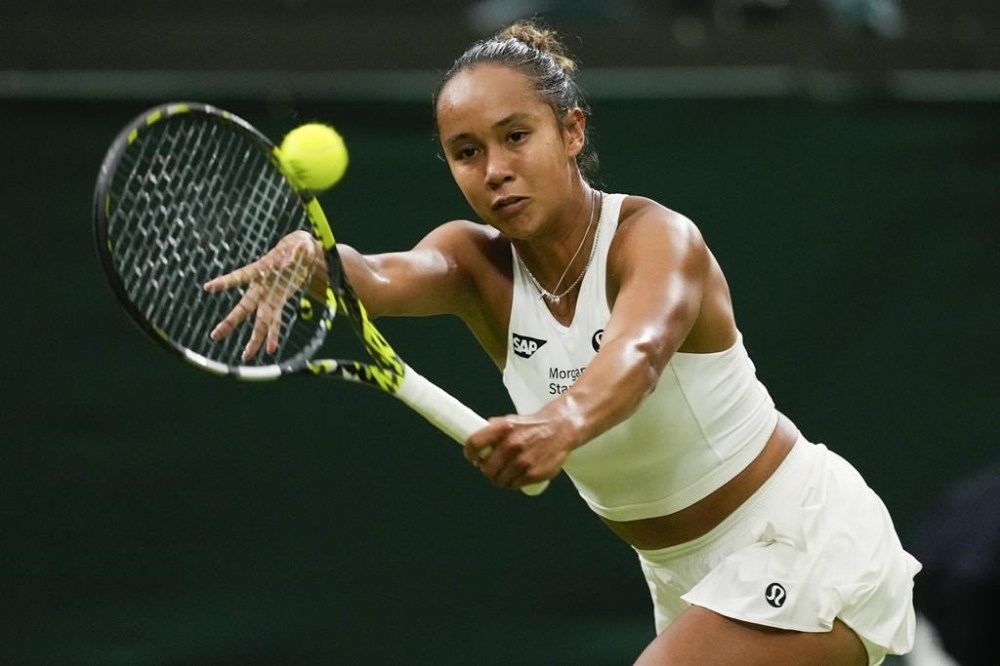 Leylah Fernandez of Canada plays a backhand return to Caroline Wozniacki of Denmark during their second round match at the Wimbledon tennis championships in London, Thursday, July 4, 2024. Fernandez, of Laval, Que., faces a tough first-round match in the women's singles at the Paris Olympics. THE CANADIAN PRESS/AP/Mosa'ab Elshamy