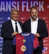 Barcelona's new coach Hansi Flick and Barcelona FC President, Joan Laporta, pose for a photo during an official presentation event of the new coach in Barcelona, Spain, Thursday, July 25, 2024. FC Barcelona and Hansi Flick have reached an agreement for the German to become men's first team football coach until 30 June 2026. (AP Photo/Joan Monfort)