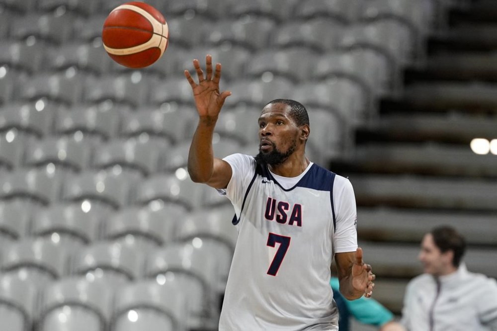 Kevin Durant gets a pass as the United State's men's team practiced before the start of the basketball competition at the 2024 Summer Olympics, Wednesday, July 24, 2024 in Villeneuve-d'Ascq, France. (AP Photo/Michael Conroy)