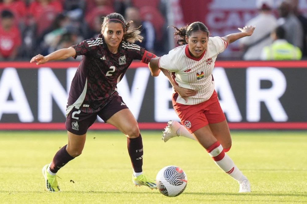 Canada's Jayde Riviere holds off Mexico's Kenti Robles during first half international friendly soccer action in Toronto, on Tuesday, June 4, 2024. Defender Riviere will not play in the Canadian women's soccer team's opening match against New Zealand due to an ankle injury.THE CANADIAN PRESS/Chris Young