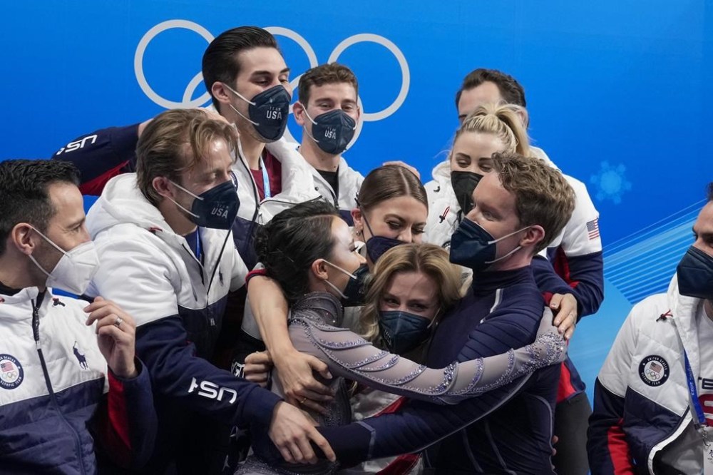 FILE - Madison Chock and Evan Bates, of the United States, reacts after the team ice dance program during the figure skating competition at the 2022 Winter Olympics, Monday, Feb. 7, 2022, in Beijing.The United States figure skating team was formally confirmed as the 2022 Beijing Olympics champion by a sports court ruling. It opens the way to the skaters getting their medals at a presentation ceremony at the Paris Summer Games. (AP Photo/Natacha Pisarenko, File)