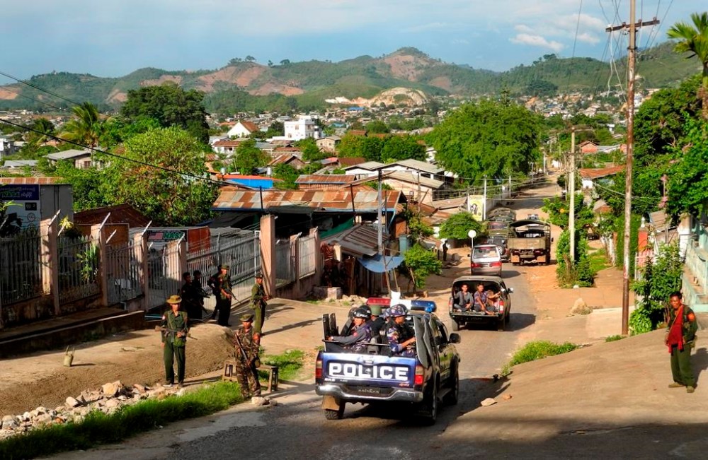 FILE - Army officers stand guard as police officers patrol in Lashio, northern Shan State, Myanmar, on May 29, 2013. Ethnic armed groups claimed on Thursday July 25, 2024 to have captured two strategically important towns in northeastern Myanmar: Lashio, which houses the major regional military headquarters, and Mogok, the center of the country’s lucrative gem-mining industry. (AP Photo/Ain Khaing Myae, File)