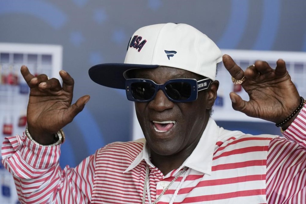 Flavor Flav attends an interview with The Associated Press at the USA house ahead of the 2024 Summer Olympics, Thursday, July 25, 2024, in Paris, France. The clock-wearing icon from the rap group Public Enemy is the official hype man for USA Water Polo, and he is bringing his boundless energy to the pool at the Paris Game. (AP Photo/Luca Bruno)
