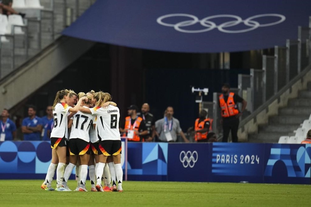 Germany celebrates their second goal scored by Lea Schueller during the women's Group B soccer match between Germany and Australia at the Velodrome stadium during the 2024 Summer Olympics, Thursday, July 25, 2024, in Marseille, France. (AP Photo/Daniel Cole)