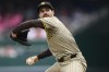 San Diego Padres starting pitcher Dylan Cease winds up to throw during the inning of a baseball game against the Washington Nationals, Thursday, July 25, 2024, in Washington. (AP Photo/John McDonnell)