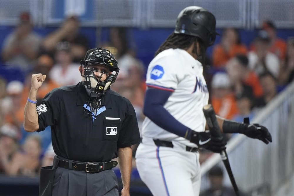 Miami Marlins' Josh Bell argues a call with home plate umpire Alfonso Marquez after Bell struck out swinging, during the first inning of a baseball game against the Baltimore Orioles, Thursday, July 25, 2024, in Miami. (AP Photo/Wilfredo Lee)