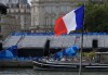 A worker walks past empty stands along the Seine River, Thursday, July 25, 2024 in Paris, France. THE CANADIAN PRESS/Adrian Wyld