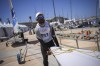 CORRECTS SPELLING OF FIRST NAME TO VILIAME NOT VILIAM - Fiji's Viliame Ratulu, competing in the men's dinghy sailing competition, prepares his dinghy for a practice session at the Marseille Marina during the 2024 Summer Olympics, Thursday, July 25, 2024, in Marseille, France. (AP Photo/Daniel Cole)