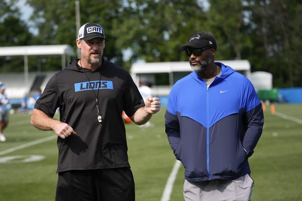 Detroit Lions head coach Dan Campbell, left, talks with general manager Brad Holmes after an NFL football practice in Allen Park, Mich., Thursday, July 25, 2024. (AP Photo/Paul Sancya)