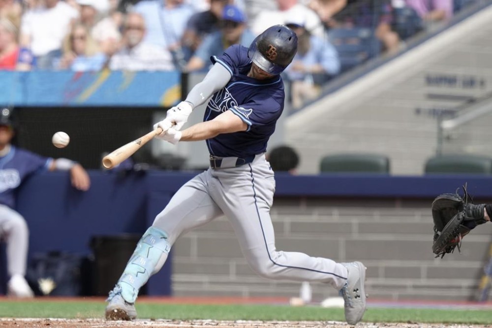 Tampa Bay Rays designated hitter Brandon Lowe hits an RBI double off Toronto Blue Jays pitcher Chris Bassitt during third inning American League MLB baseball action in Toronto on Thursday, July 25, 2024. THE CANADIAN PRESS/Chris Young
