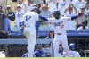Los Angeles Dodgers' Teoscar Hernandez (37) congratulates teammate Nick Ahmed (12) for hitting a home run during the eighth inning of a baseball game against the San Francisco Giants in Los Angeles, Thursday, July 25, 2024. (AP Photo/Eric Thayer)