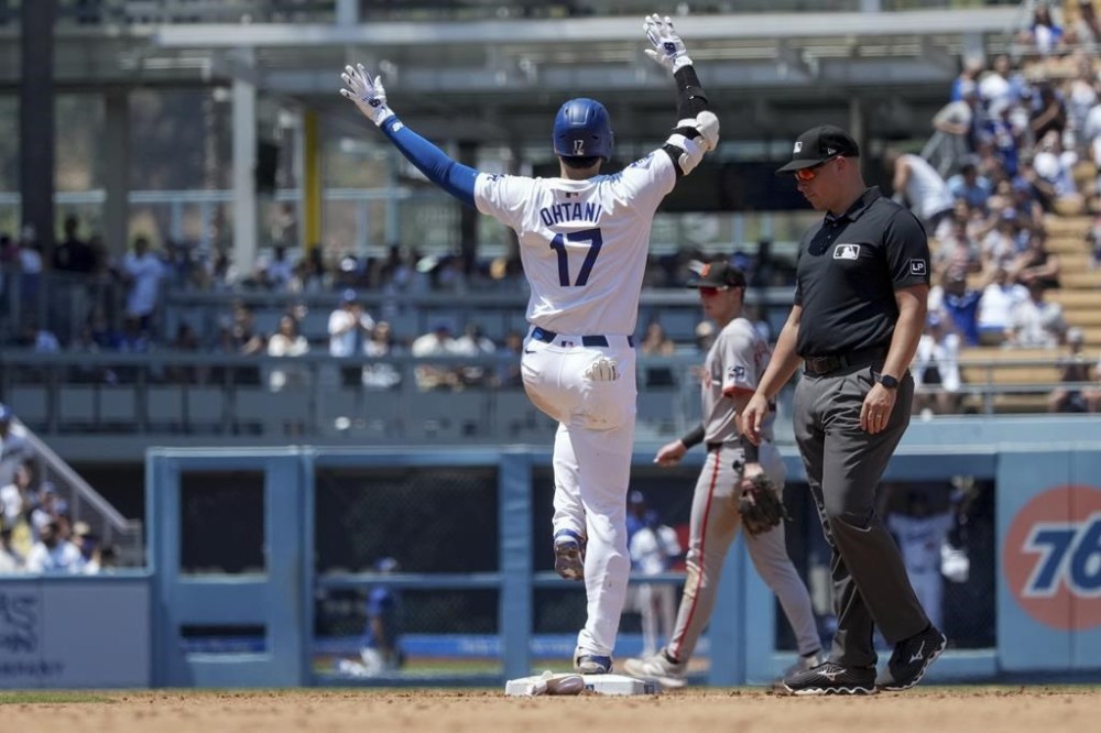 Los Angeles Dodgers designated hitter Shohei Ohtani (17) celebrates after hitting a single during the fourth inning of a baseball game against the San Francisco Giants in Los Angeles, Thursday, July 25, 2024. (AP Photo/Eric Thayer)