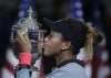 FILE - In this Sept. 8, 2018, file photo, Naomi Osaka, of Japan, kisses the trophy after the women's final of the U.S. Open tennis tournament in New York. (AP Photo/Julio Cortez, File)