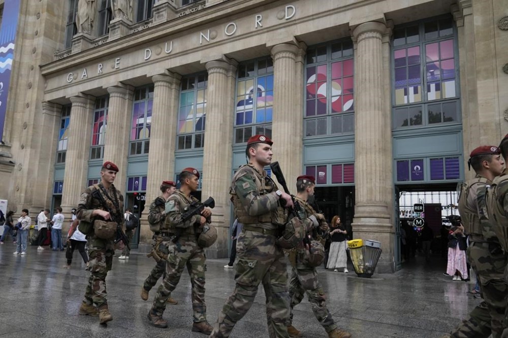 Soldiers patrol outside Gare du Nord train station at the 2024 Summer Olympics, Friday, July 26, 2024, in Paris, France. Hours away from the grand opening ceremony of the Olympics, high-speed rail traffic to the French capital was severely disrupted on Friday by what officials described as